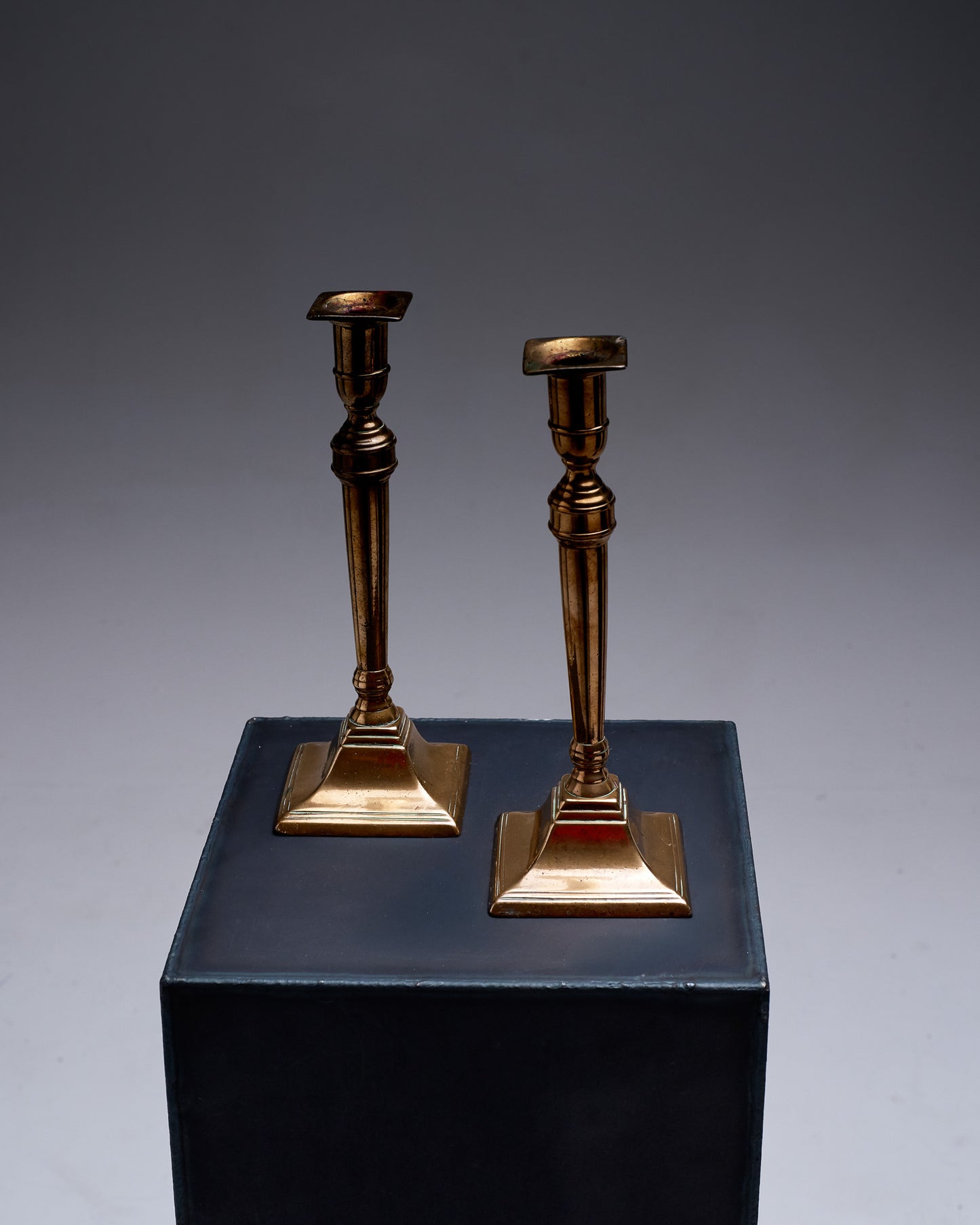 Pair of gold-plated metal column candlesticks, 1970s