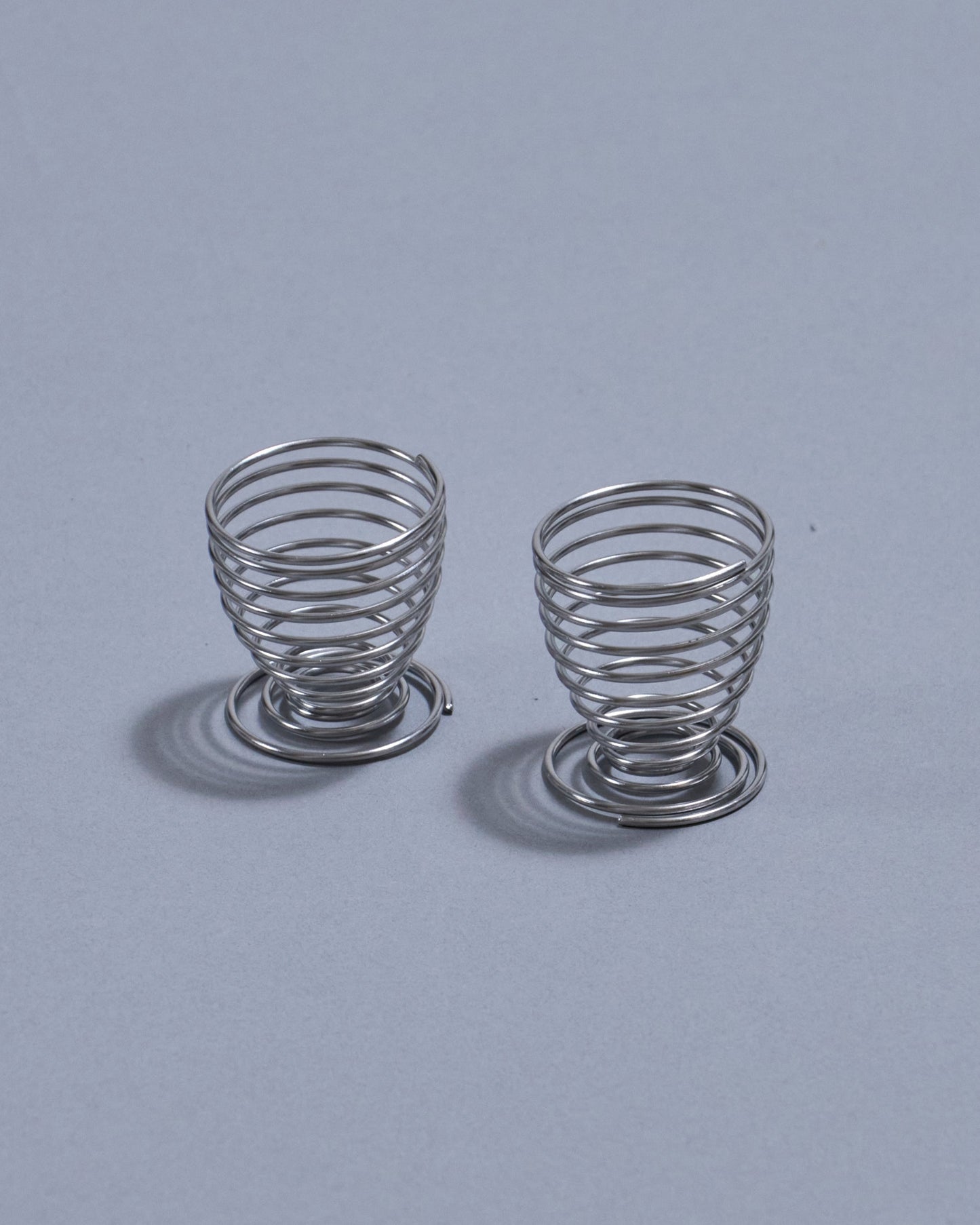 PAIR OF METAL SPRING EGG CUPS