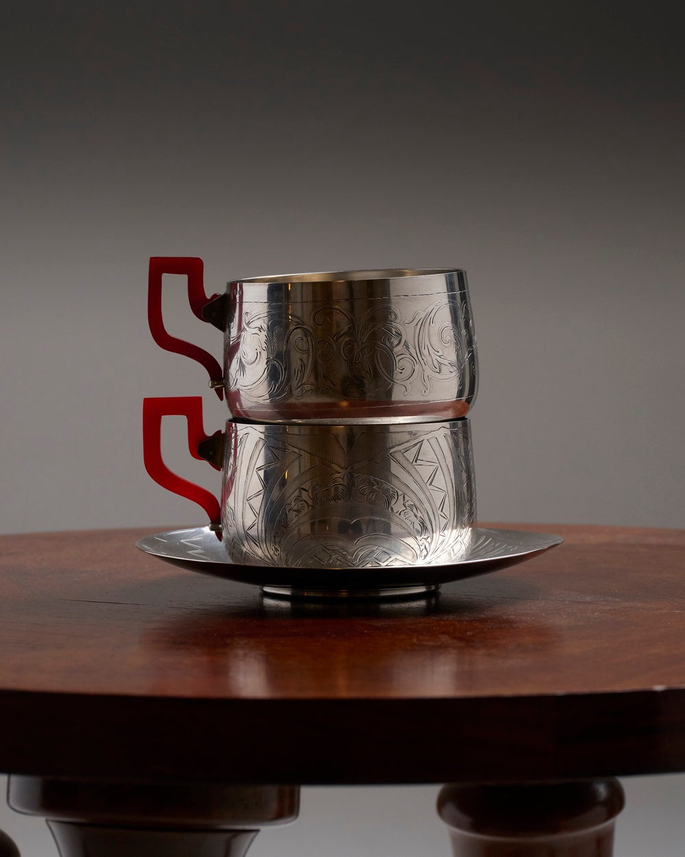 PAIR OF SILVER-PLATED METAL AND BAKELITE CUPS, 1930s