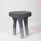 Un tabouret en plâtre et sable gris clair et noir du designer Paul Hardy. En parfait état.