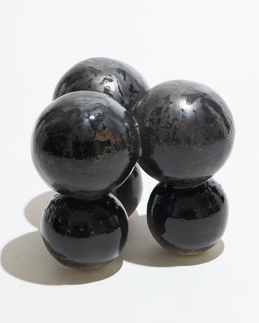 Awkward stool in metallic black sandstone