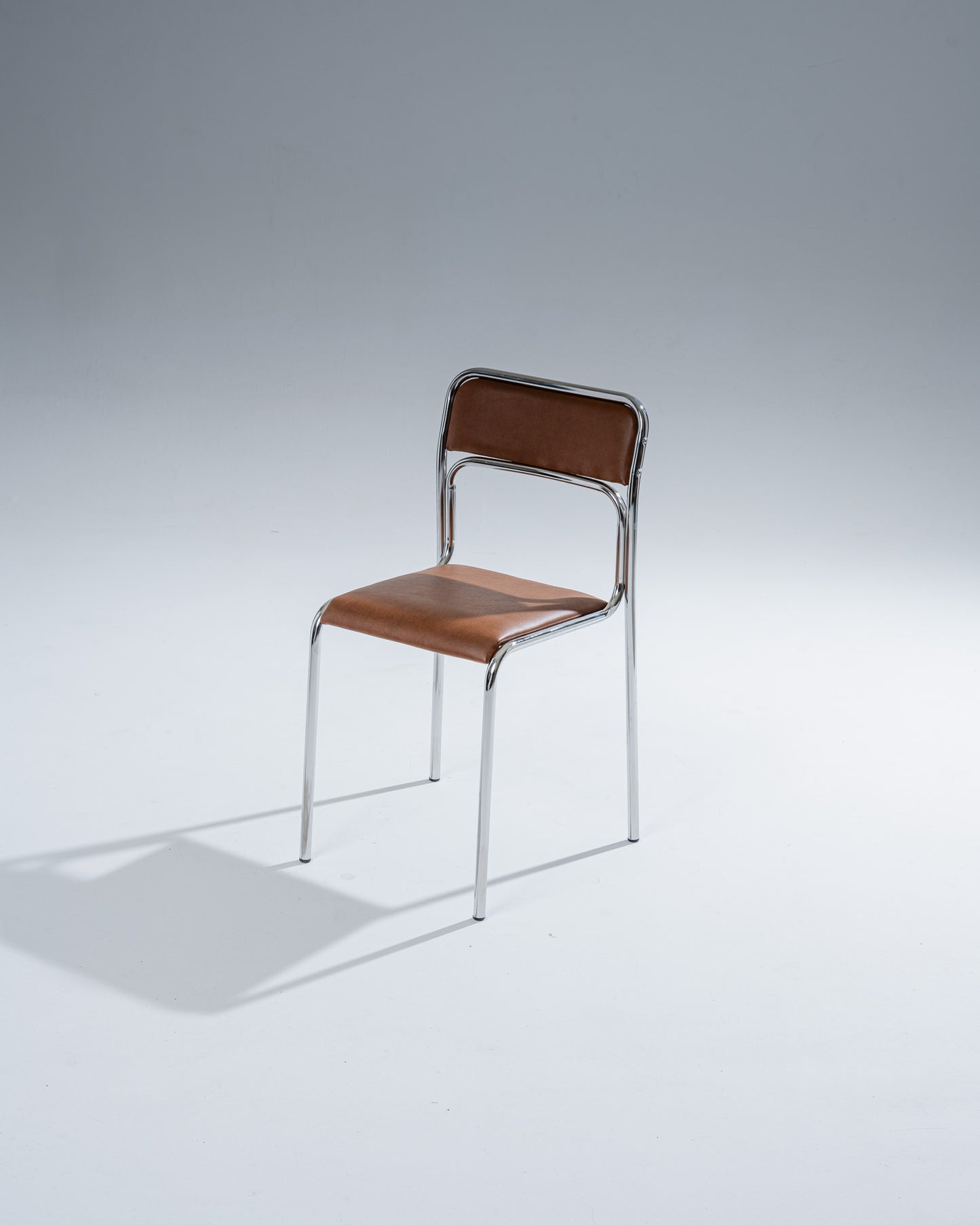 PAIR OF TUBULAR STEEL AND COGNAC LEATHERETTE CHAIRS, 1980s
