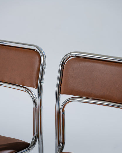 PAIR OF TUBULAR STEEL AND COGNAC LEATHERETTE CHAIRS, 1980s