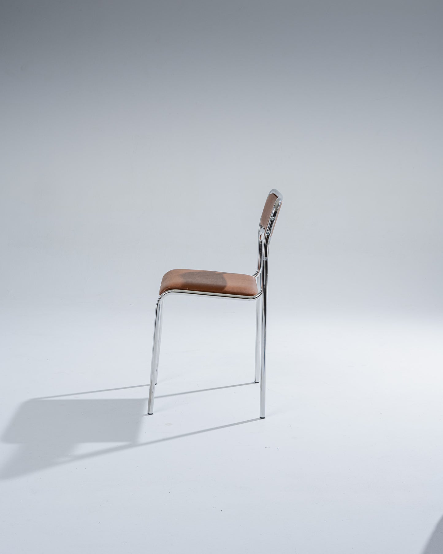 PAIR OF TUBULAR STEEL AND COGNAC LEATHERETTE CHAIRS, 1980s