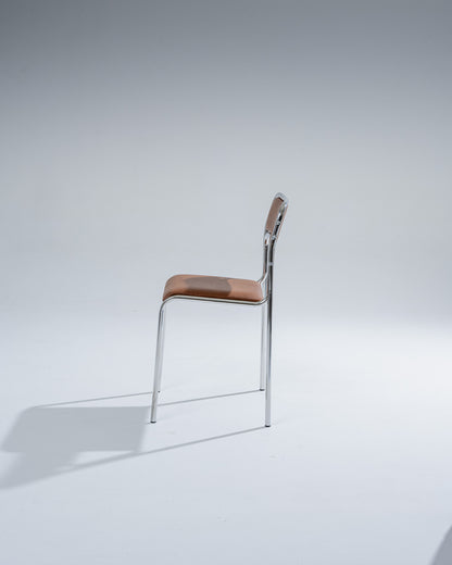 SET OF 4 CHAIRS IN TUBULAR STEEL AND COGNAC LEATHERETTE, 1980s