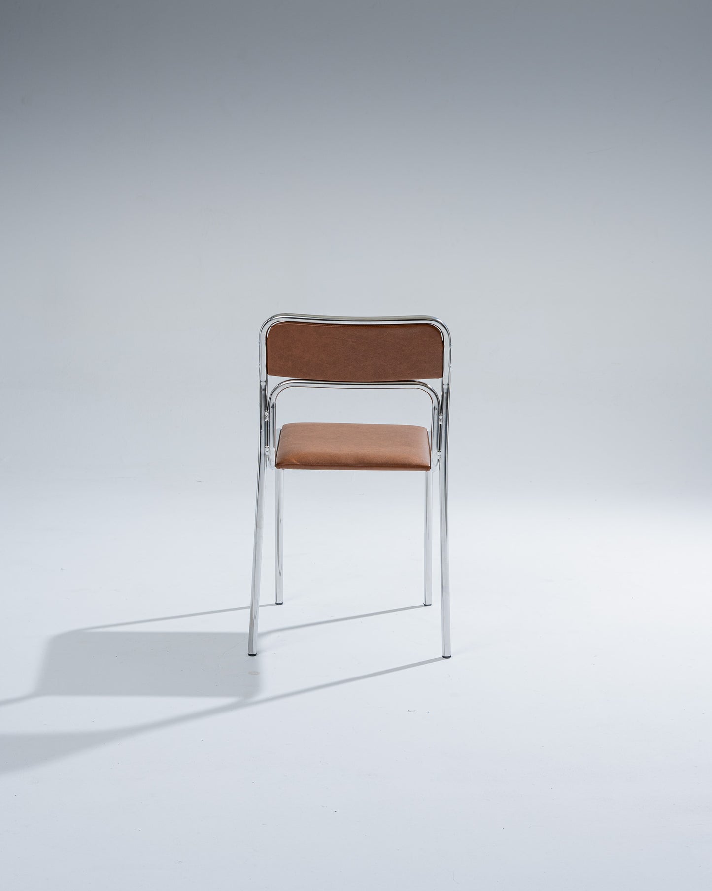 TUBULAR STEEL AND COGNAC LEATHERETTE CHAIR, 1980s