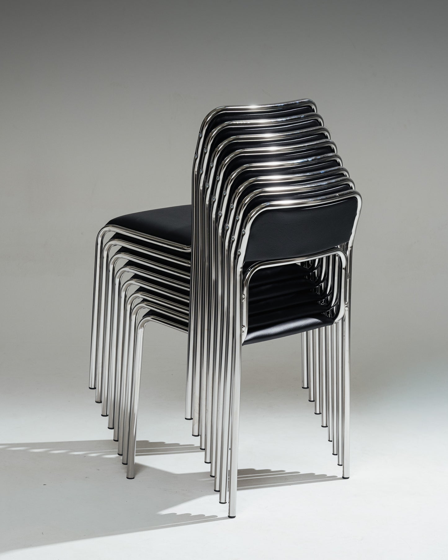 SET OF 4 BLACK FAUX LEATHER AND TUBULAR STEEL CHAIRS, 1980s
