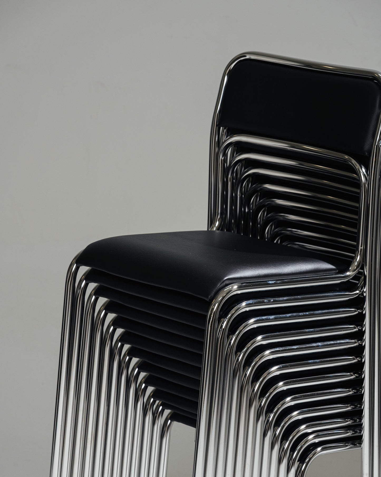 SET OF 4 BLACK FAUX LEATHER AND TUBULAR STEEL CHAIRS, 1980s