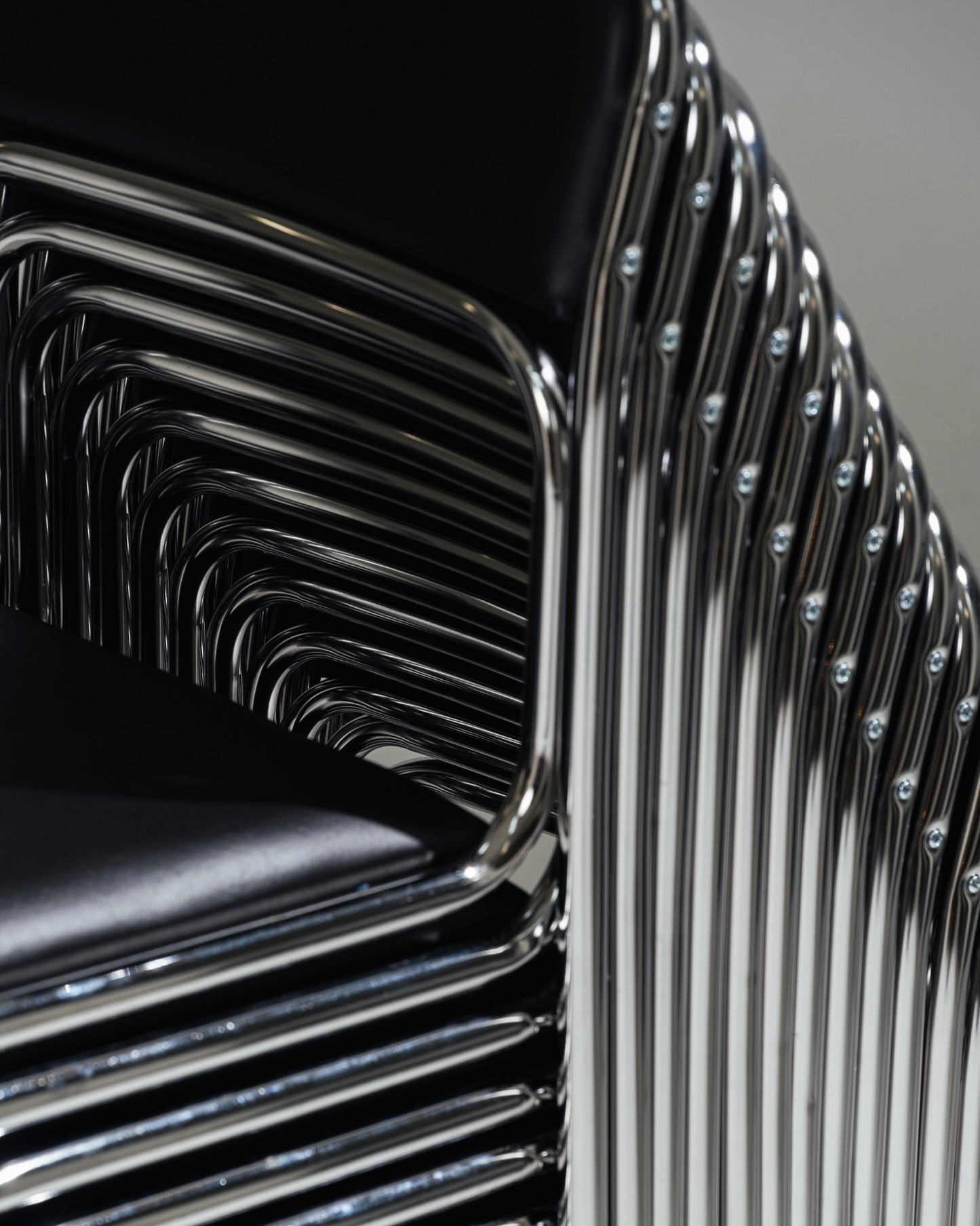 SET OF 4 BLACK FAUX LEATHER AND TUBULAR STEEL CHAIRS, 1980s