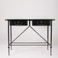  Bureau d'exception du designer Jacques Adnet (1900-1984), années 1940. Le piétement est en fer forgé patiné noir, le plateau en verre et les détails du bureau sont en cuir et laiton. Les deux tiroirs coulissants sont recouverts de cuir piqué à la main. Jacques Adnet a laissé une empreinte indélébile dans le monde du design avec son style distinctif et son innovation constante, il collabora notamment avec la maison Hermès sur des meubles en cuir de haute qualité, sa marque de fabrique.