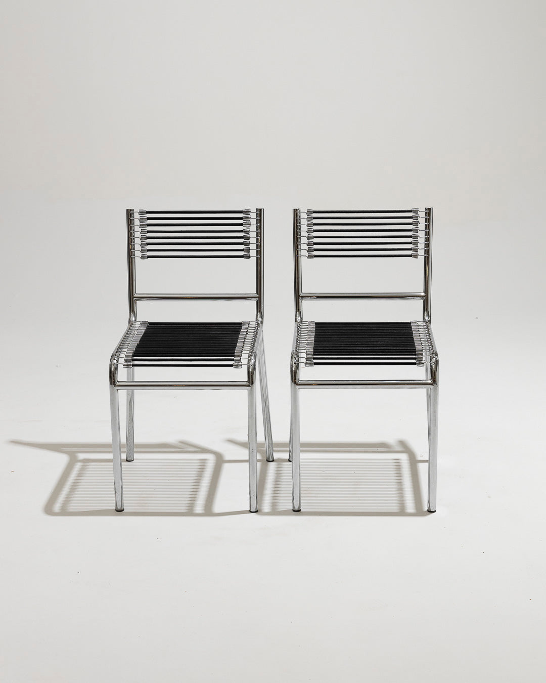 PAIR OF STEEL AND ELASTIC CORD CHAIRS, RENÉ HERBST, 1970s