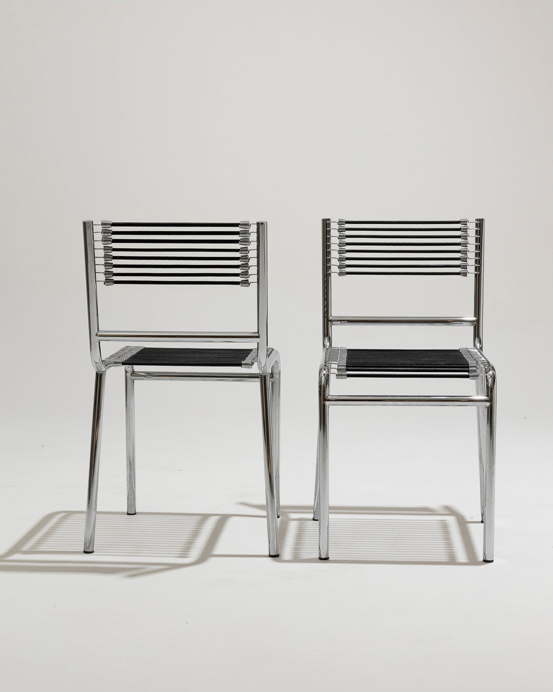 PAIR OF STEEL AND ELASTIC CORD CHAIRS, RENÉ HERBST, 1970s