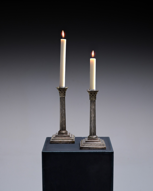 PAIR OF SILVER-PLATED METAL COLUMN CANDLESTICKS, 1950s