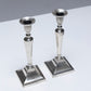 PAIR OF METAL FLAMBEAU CANDLESTICKS