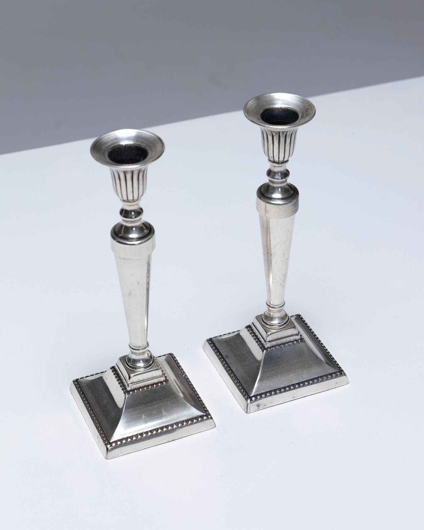 PAIR OF METAL FLAMBEAU CANDLESTICKS