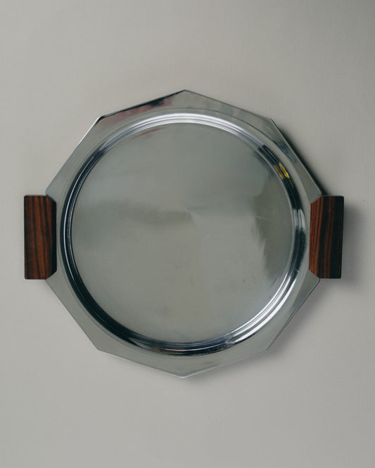 Plateau de service octogonal en métal argenté, orné de poignées latérales en palissandre. Travail français des années 1930, typique du style Art Déco par l'équilibre géométrique et l'association de matériaux contrastés.

Bon état général, présentant quelques traces d'usage conformes à l'âge.