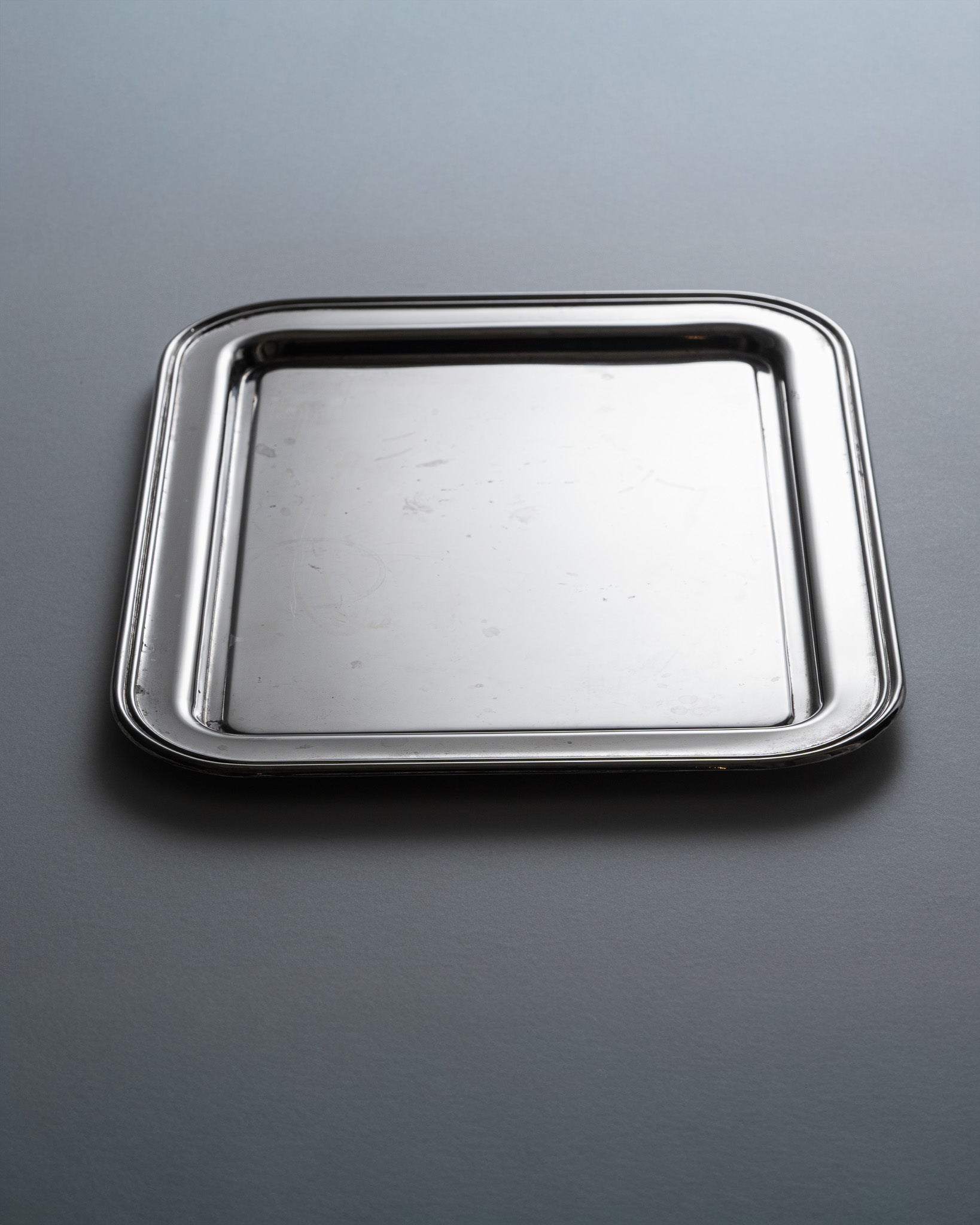 Plateau de service en métal argenté. Bon état général. À noter, quelques traces d'usures conformes à l'âge et à l'usage.