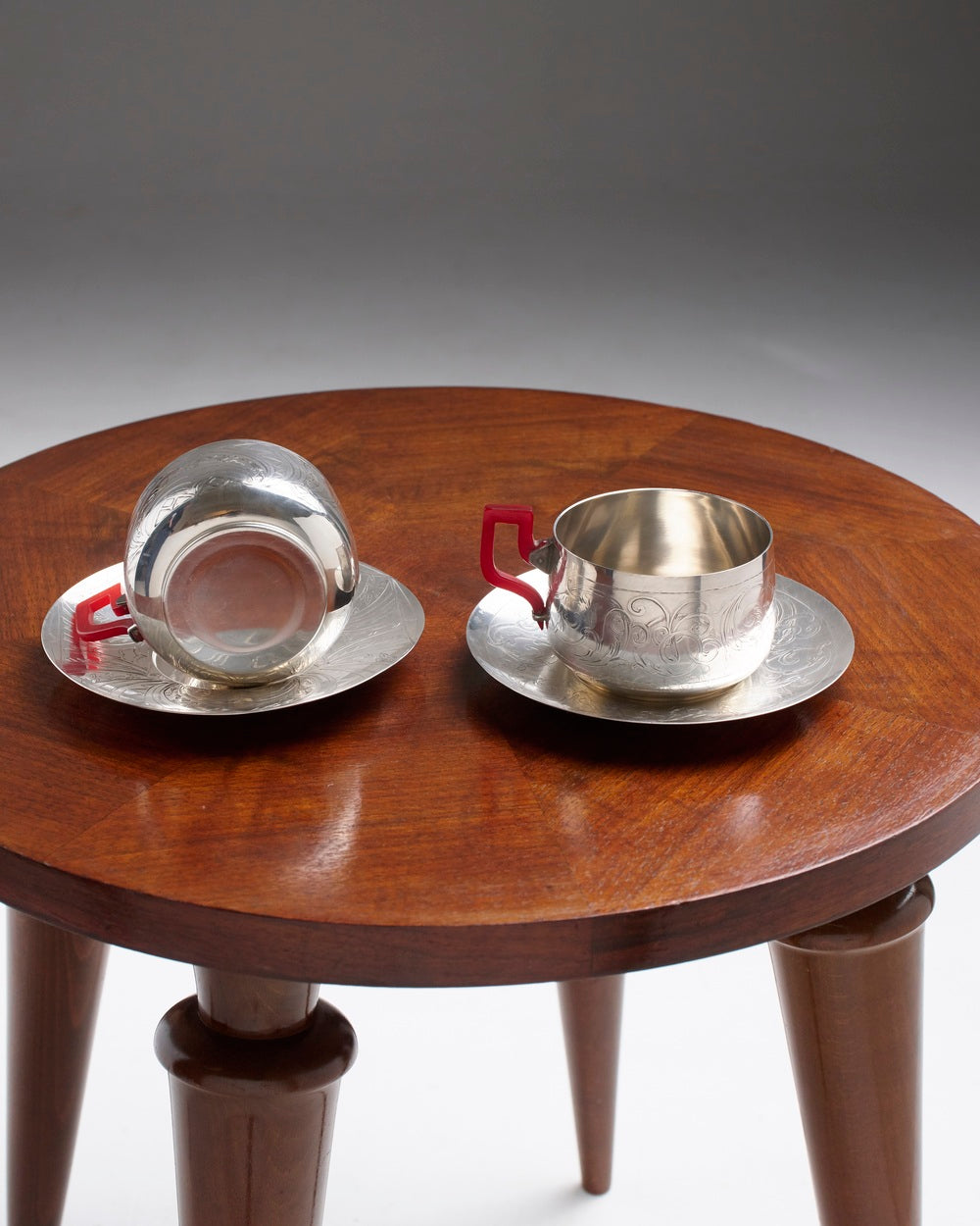 PAIR OF SILVER-PLATED METAL AND BAKELITE CUPS, 1930s