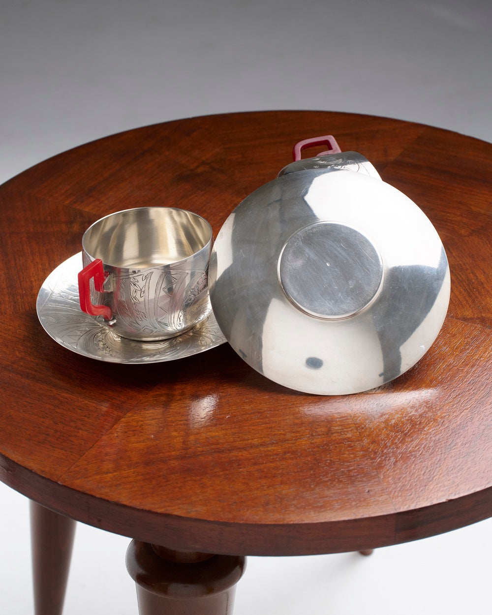 PAIR OF SILVER-PLATED METAL AND BAKELITE CUPS, 1930s