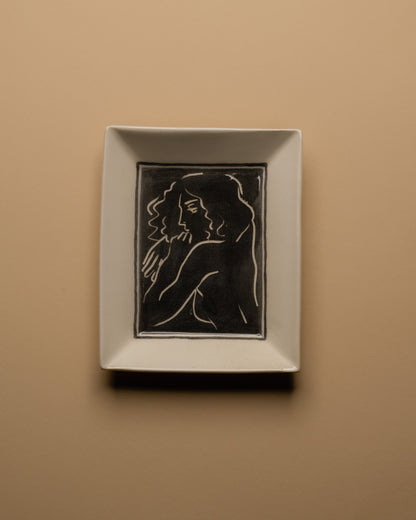 Vide-poche d’atelier en céramique émaillée blanc, pièce unique signée « Eldarov. T 2024 » au revers. Sa forme rectangle à bords incurvés et la finesse de son émail témoignent d’une fabrication artisanale contemporaine. Pièce décorative à usage polyvalent, idéale pour accueillir des objets du quotidien ou comme élément sculptural sur un meuble d’appoint.