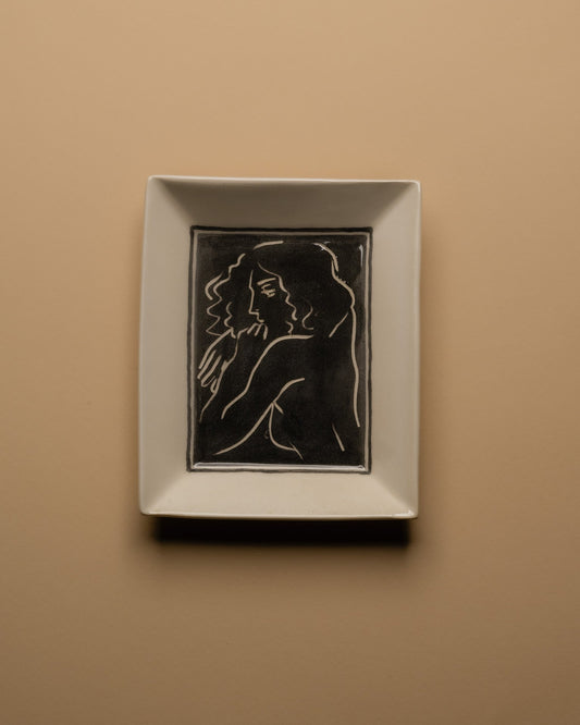 Vide-poche d’atelier en céramique émaillée blanc, pièce unique signée « Eldarov. T 2024 » au revers. Sa forme rectangle à bords incurvés et la finesse de son émail témoignent d’une fabrication artisanale contemporaine. Pièce décorative à usage polyvalent, idéale pour accueillir des objets du quotidien ou comme élément sculptural sur un meuble d’appoint.